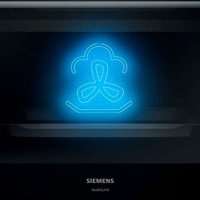 Billedet viser et ovnrum med en neonillustration af ovnfunktionen damp og varmluft. 